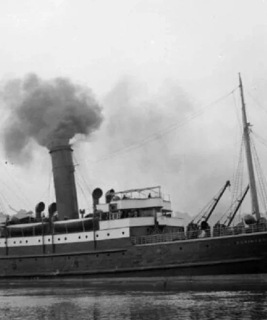 A black-and-white photograph of a 19th-century steamship on a calm body of water. The ship has a large smokestack emitting dark smoke and multiple masts. The sky is cloudy, and the ship appears to be stationary or moving slowly, possibly evoking memories of past shipwrecks or incidents at sea.